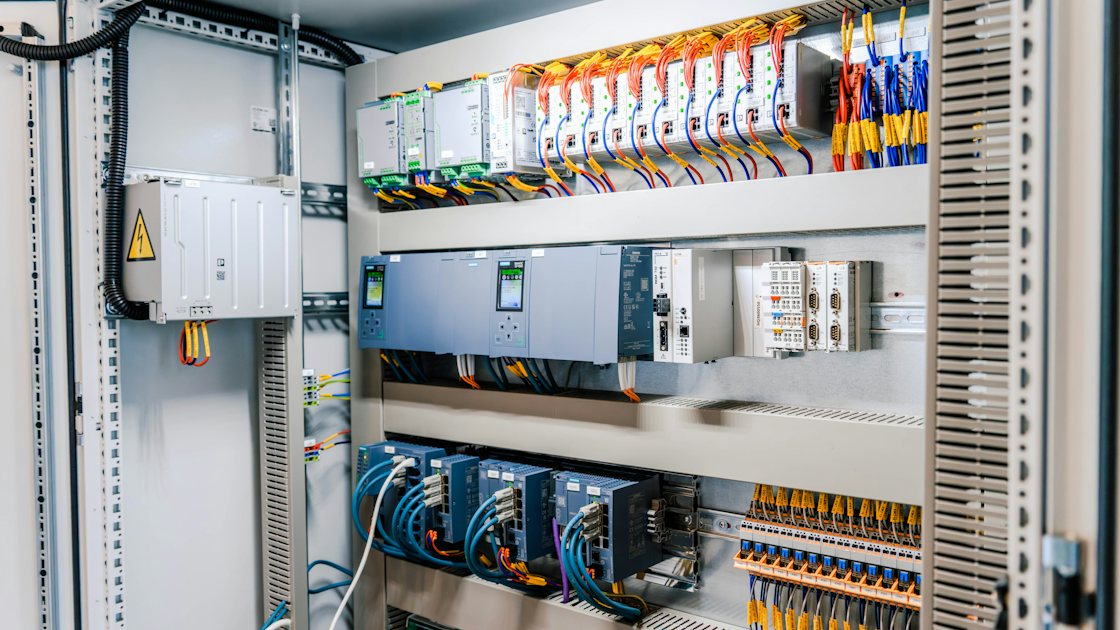 Industrial automation cabinet with controllers, drives, terminal blocks and organized wiring