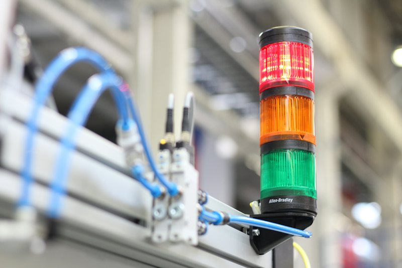 Industrial sensors and a signal tower mounted on an automation frame